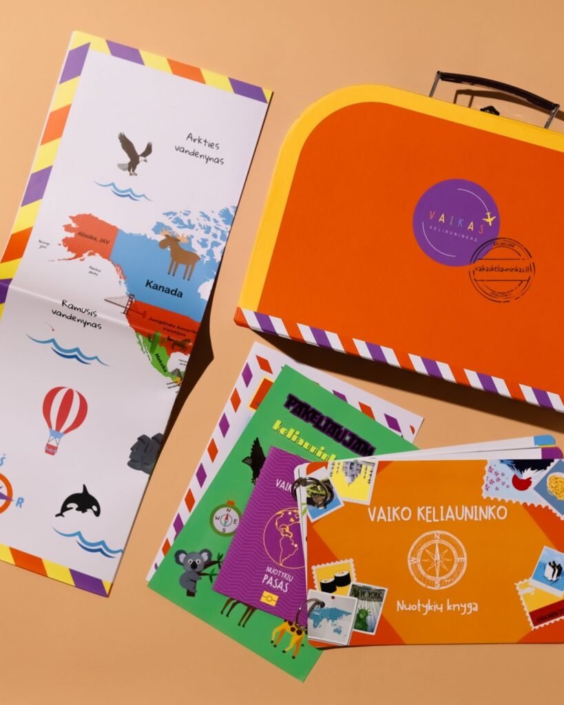 Colorful travel-themed activity set with world map pages, illustrations, and a bright orange suitcase-shaped folder for kids' learning tasks
